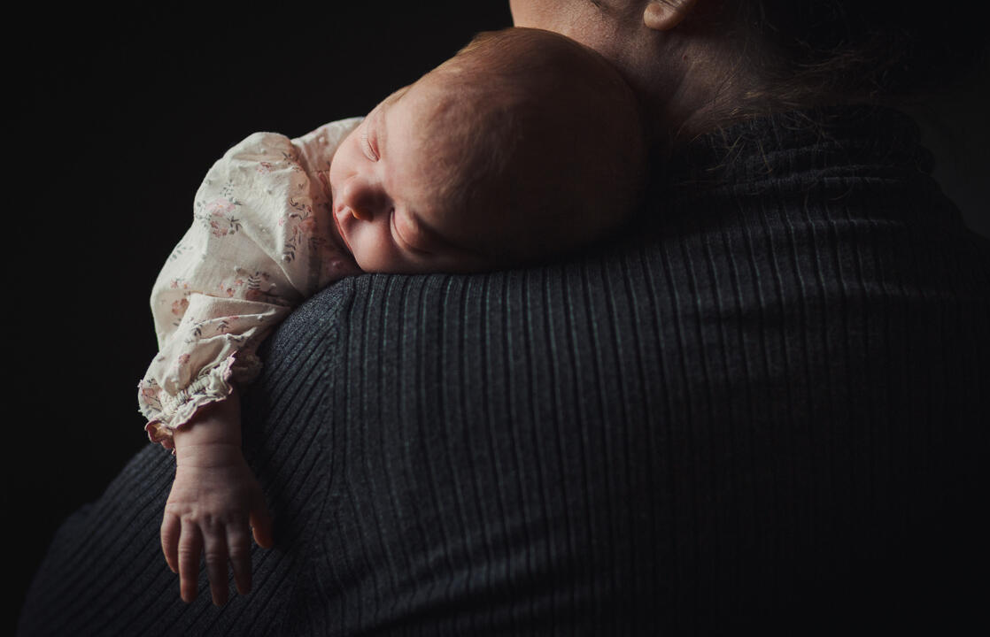 Lincolnshire Newborn Photography Newborn sleeping on mum’s shoulders in soft window light