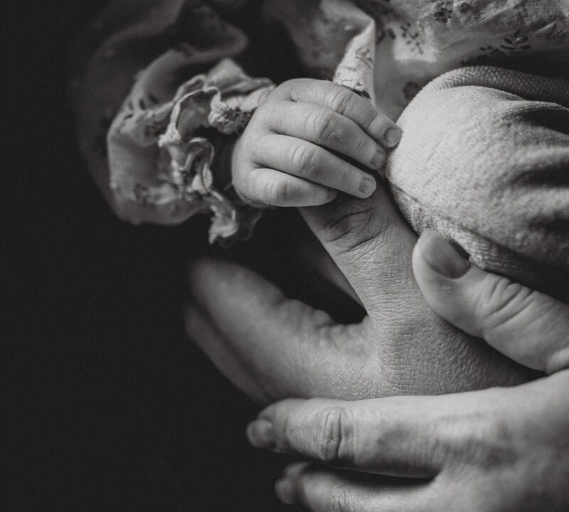 Natural Newborn Photos in Lincolnshire Newborn's tiny hands holding onto Dad's thumb
